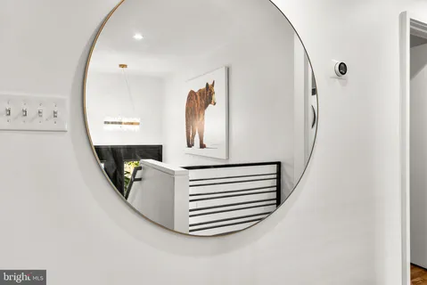 a view of an entryway with wooden floor and a front door