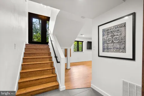 a view of an empty room with a fireplace and a potted plant
