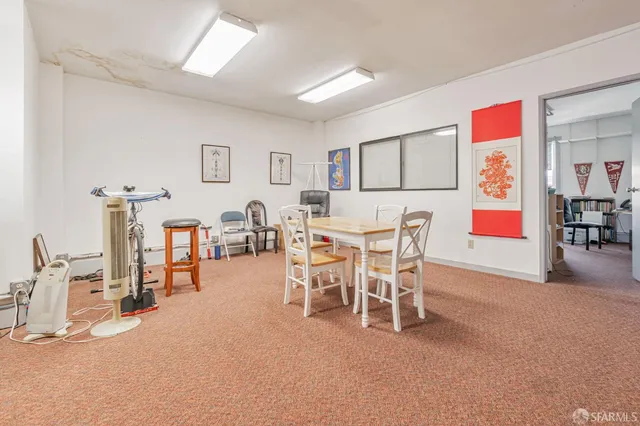 a living room with furniture gym equipment and a window