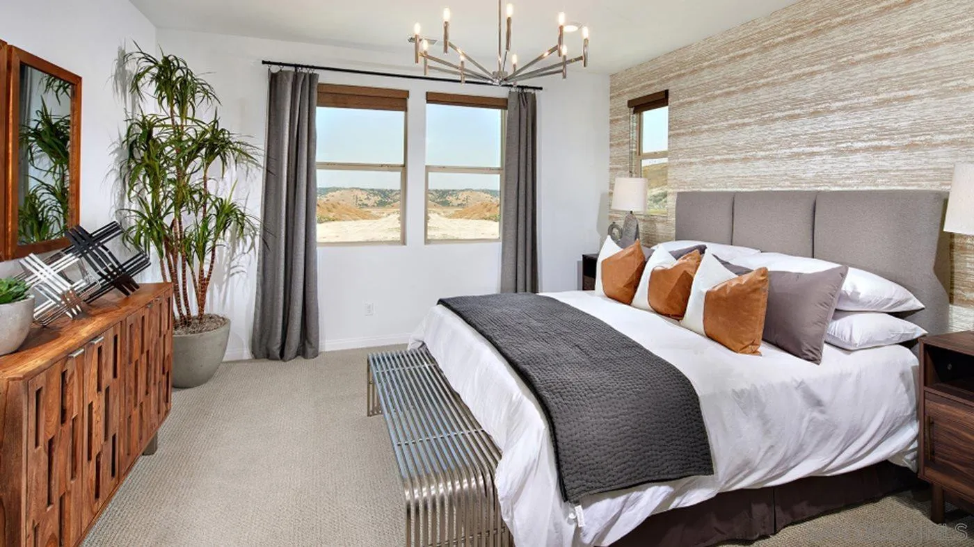 2193 Trevi Circle Chula Vista, CA 91913 - Photo 13 of 16 a bedroom with a large bed and a chandelier