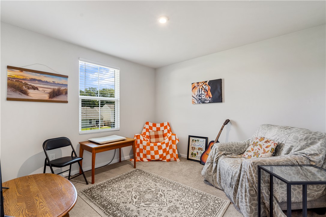 115 Queens Mill Court Pendleton, SC 29670 - Photo 22 of 32 A well-lit secondary room features plush neutral carpeting and a large window facing the neighborhood.