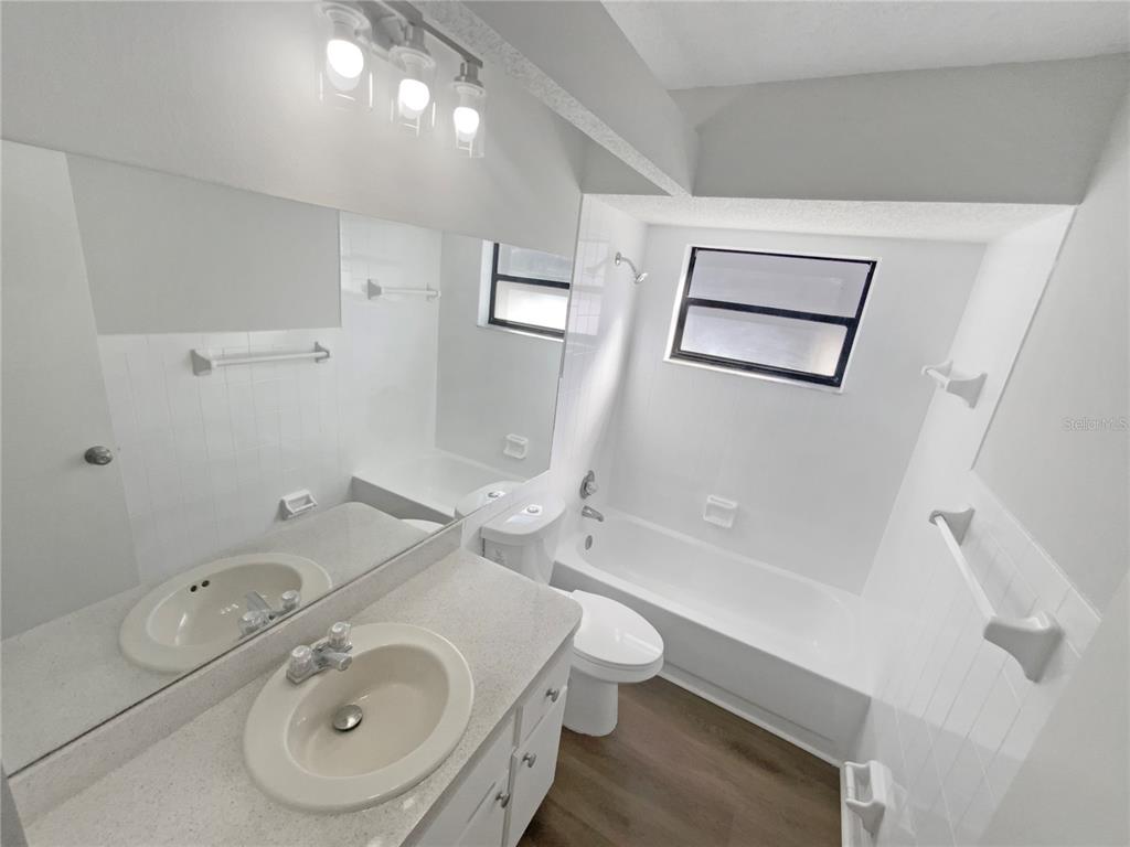 7846 Cayuga Drive New Port Richey, FL 34653 - Photo 11 of 32 a bathroom with a sink a toilet and shower