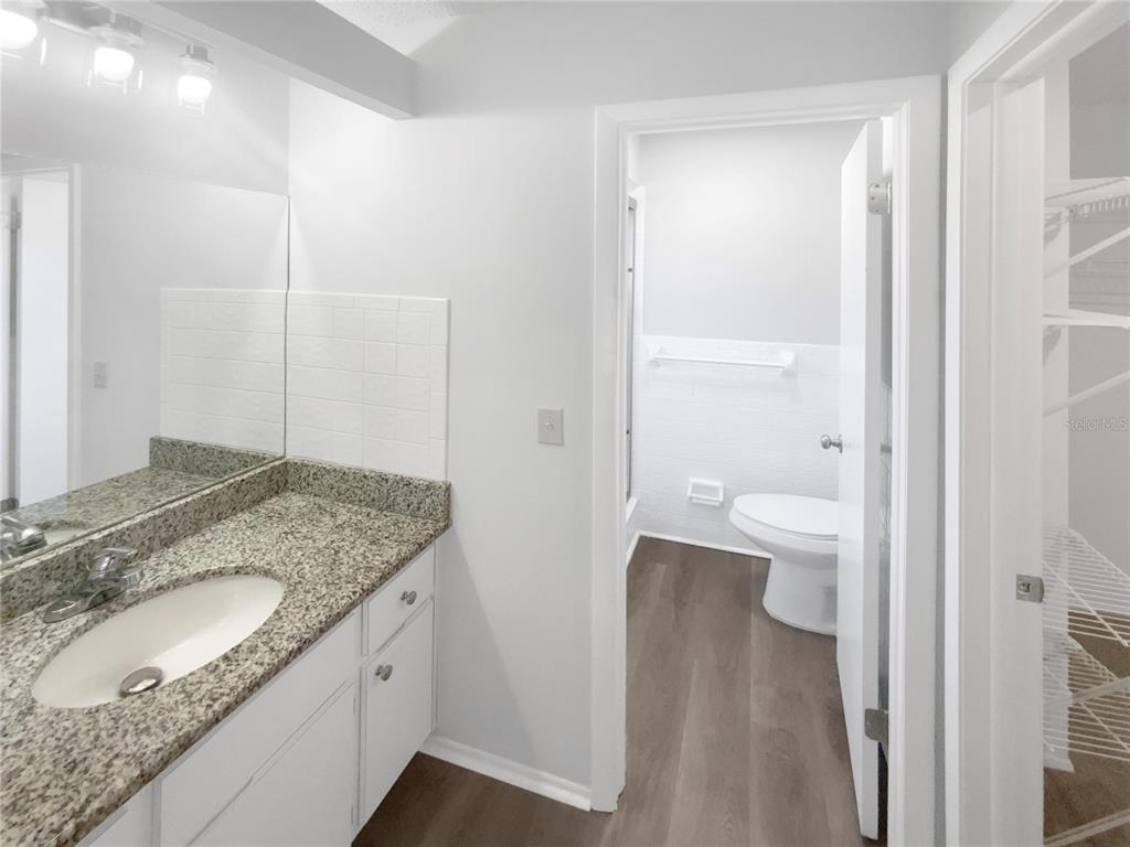 7846 Cayuga Drive New Port Richey, FL 34653 - Photo 23 of 32 a bathroom with a granite countertop sink toilet and shower