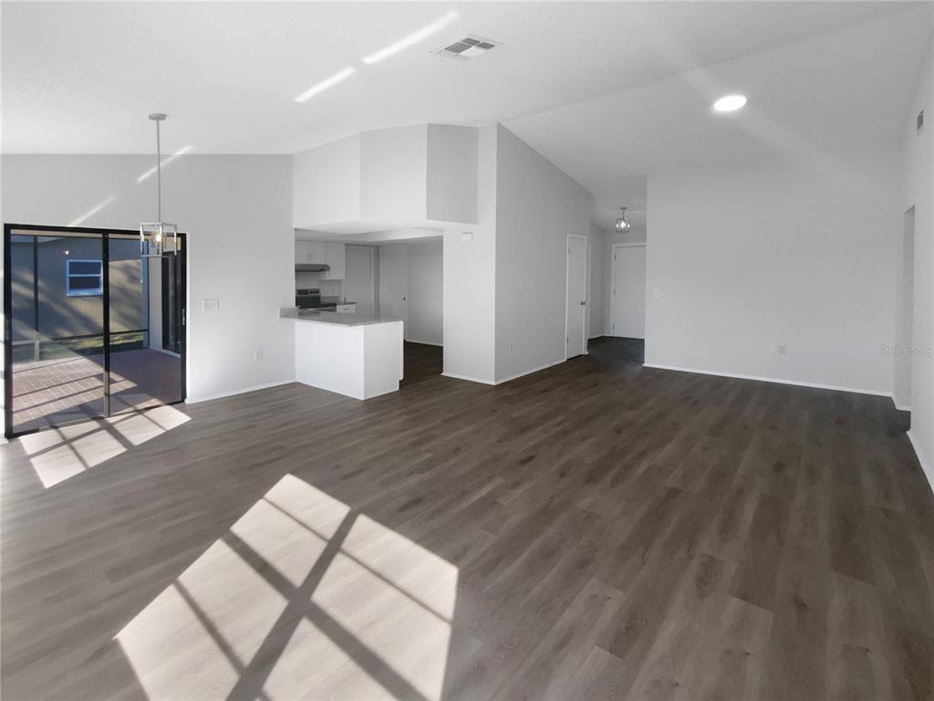 7846 Cayuga Drive New Port Richey, FL 34653 - Photo 8 of 32 an empty room with wooden floor and windows