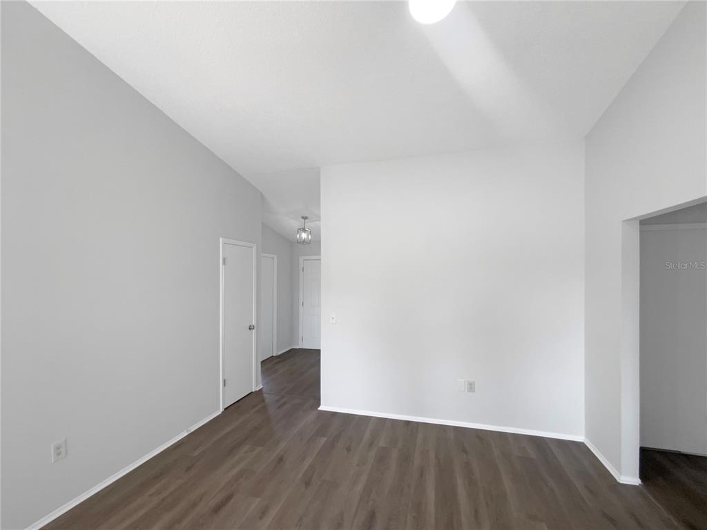 7846 Cayuga Drive New Port Richey, FL 34653 - Photo 9 of 32 a view of an empty room with wooden floor
