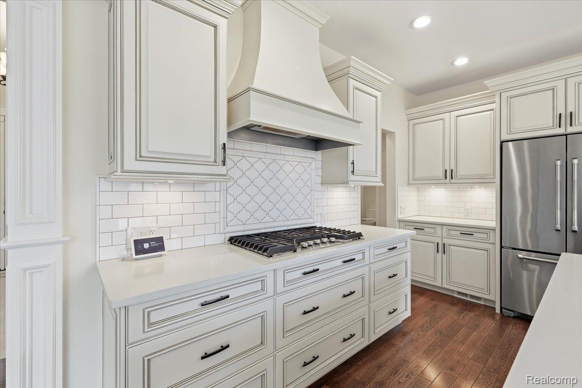 35339 West 13 Mile Road Farmington, MI 48331 - Photo 13 of 72 Kitchen with stainless steel appliances, white cabinets, dark wood-style flooring, backsplash, and recessed lighting