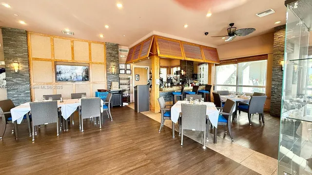 a view of building with river and trees in the background