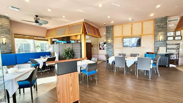a view of a patio with table and chairs and potted plants