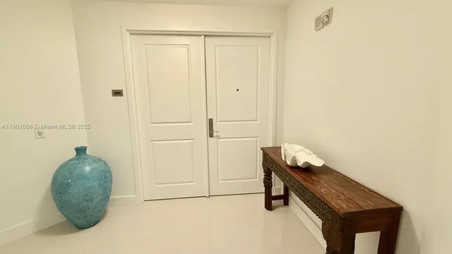 a kitchen with kitchen island granite countertop a sink and a stove top oven with wooden cabinets