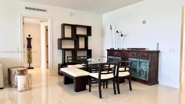 a dining room with furniture a chandelier and wooden floor