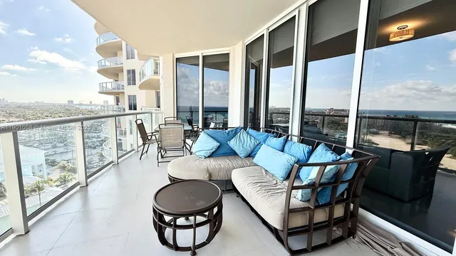 a bedroom with a bed a flat screen tv and balcony
