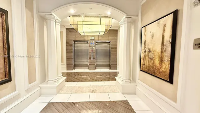 a view of a living room with furniture and floor to ceiling window