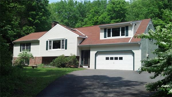 138 Pond Brook Road Huntington, MA 01050 - Photo 1 of 22 a front view of a house with a yard and garage