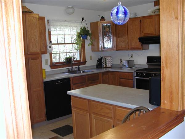 138 Pond Brook Road Huntington, MA 01050 - Photo 7 of 22 a kitchen with a sink stove and refrigerator