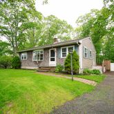 a view of a house with a yard and plants