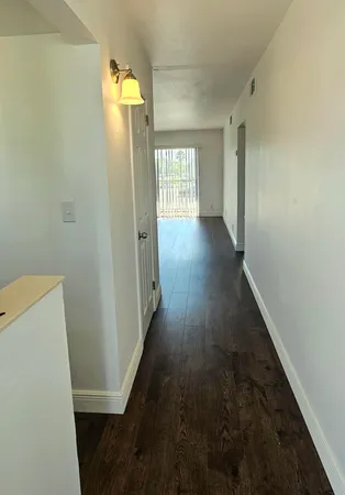 a view of hallway with wooden floor