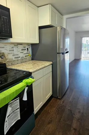 a kitchen with kitchen island a sink stainless steel appliances and cabinets