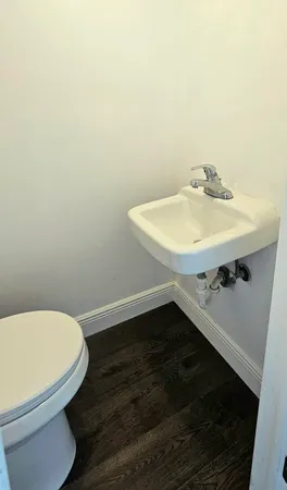 a bathroom with a sink toilet and a mirror