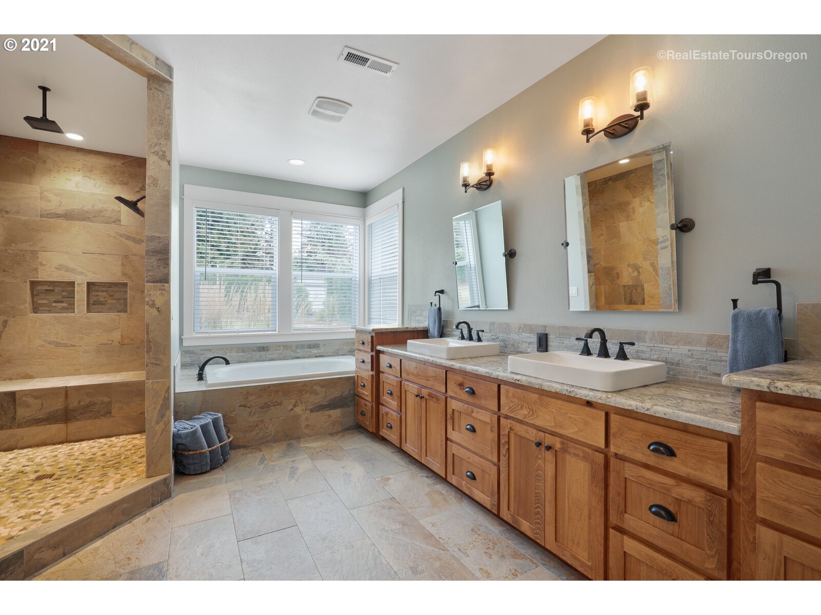 34321 Southeast Compton Road Boring, OR 97009 - Photo 10 of 32 a bathroom with a granite countertop double vanity sink a bathtub mirror and double