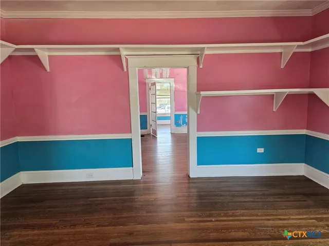 a view of an empty room window and wooden floor