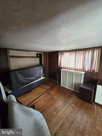 a spacious bedroom with a bed and large mirror