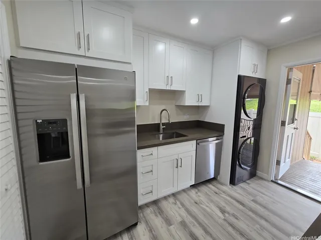 a kitchen with stainless steel appliances granite countertop a refrigerator and a sink