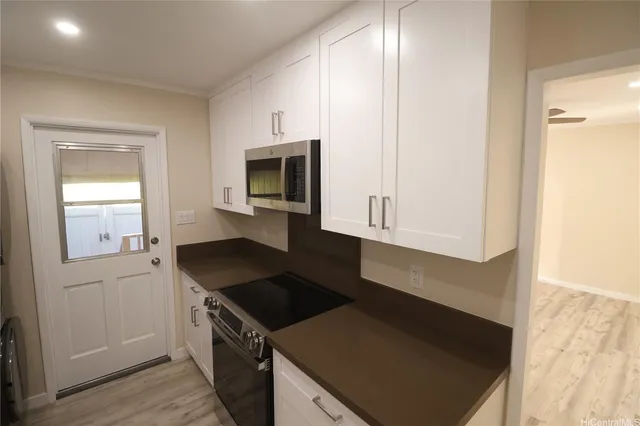 a kitchen with a sink and a stove top oven