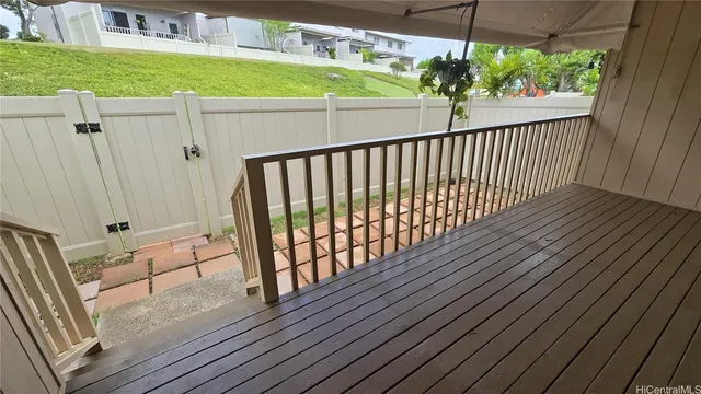 a view of a balcony with wooden floor