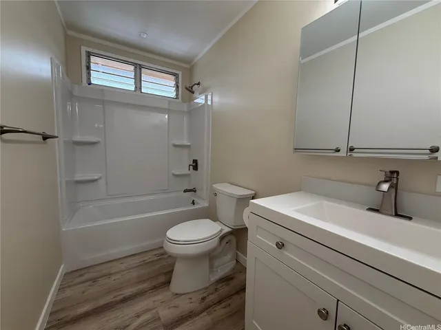 a bathroom with a sink toilet a mirror and bathtub