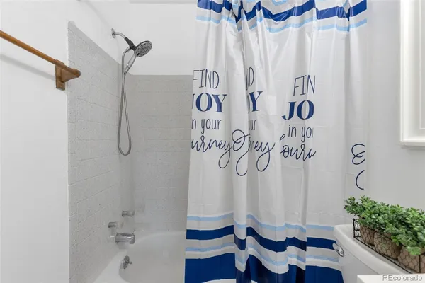 a bathroom with a shower curtain and a sink