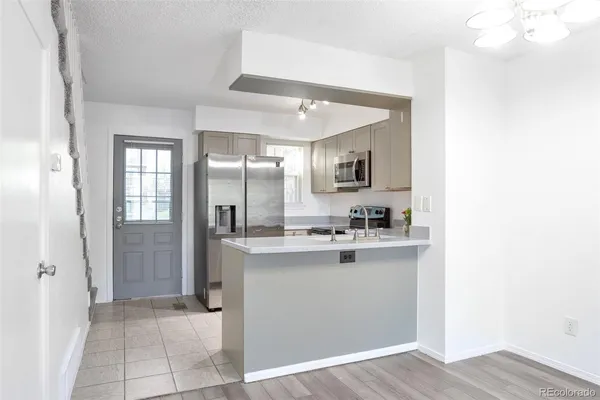 a kitchen with kitchen island a sink appliances and cabinets