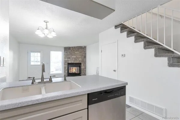 a kitchen with a sink and a fireplace