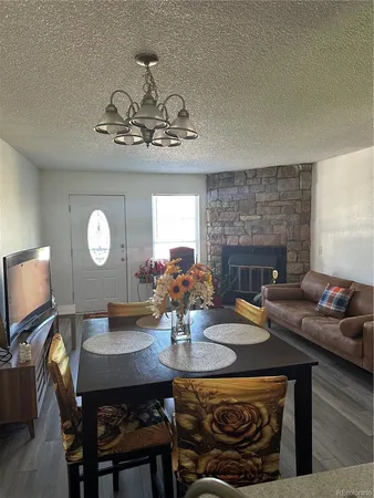 a view of a dining room with furniture and a chandelier