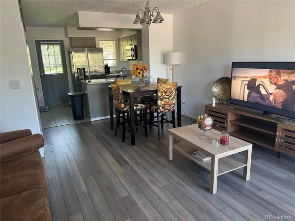 a view of a dining room with furniture and wooden floor