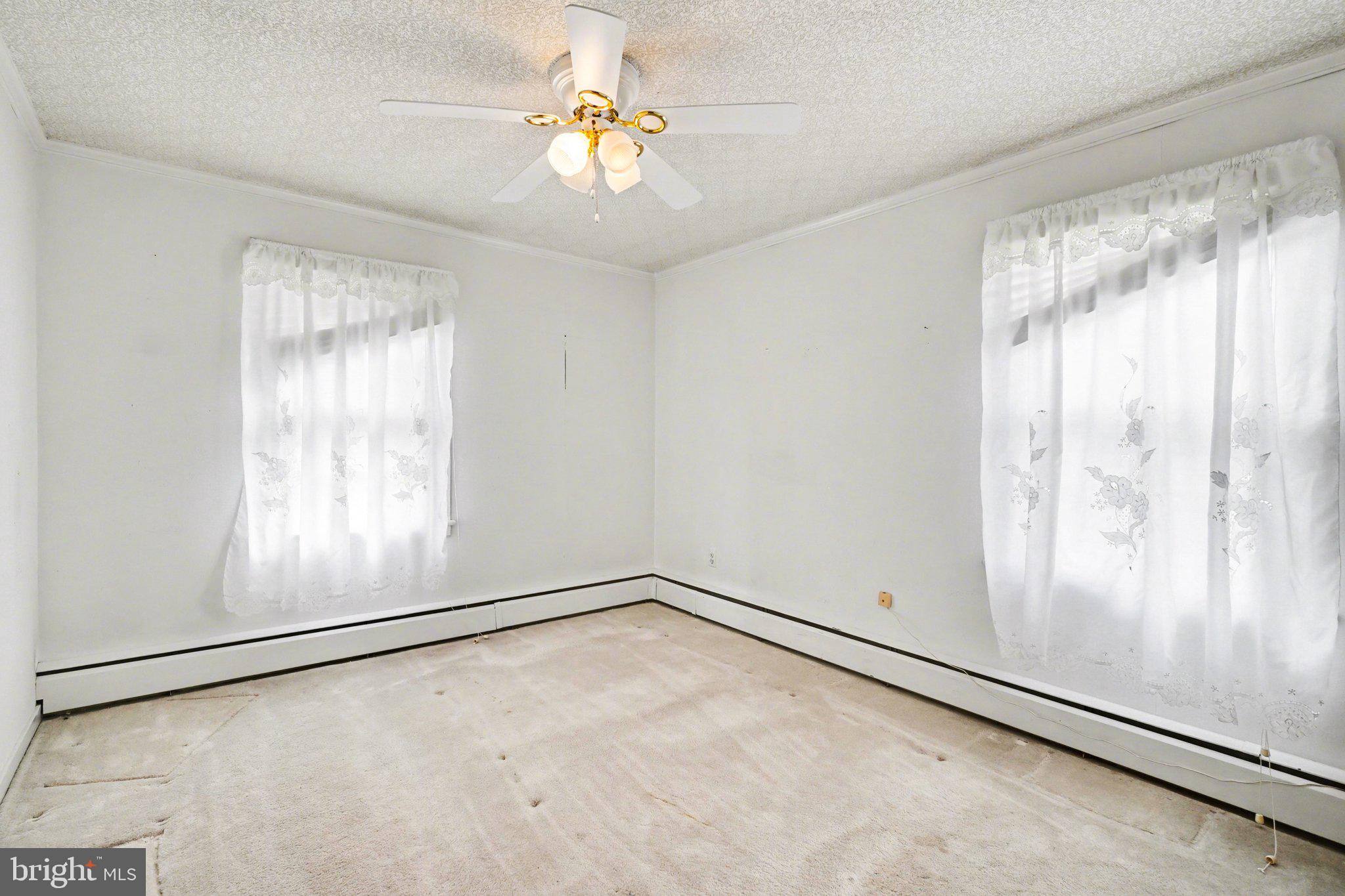 210 West Chestnut Street Cleona, PA 17042 - Photo 17 of 35 an empty room with windows and chandelier fan