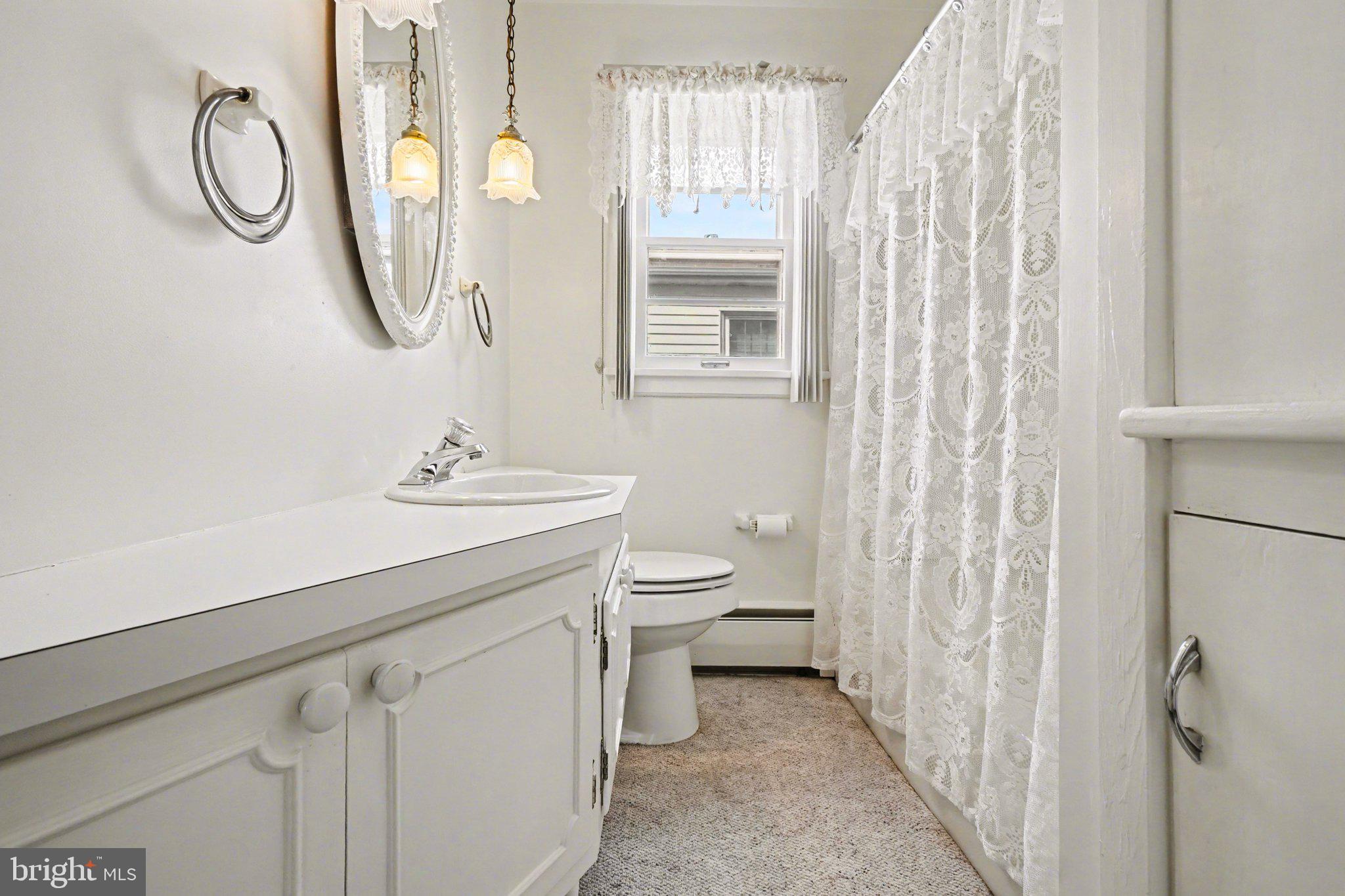 210 West Chestnut Street Cleona, PA 17042 - Photo 23 of 35 a bathroom with a granite countertop sink a toilet and a mirror