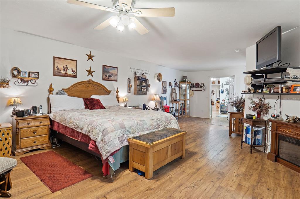 19355 Southwest 25th Place Dunnellon, FL 34431 - Photo 21 of 38 a bedroom with a bed and a flat tv screen on the dresser