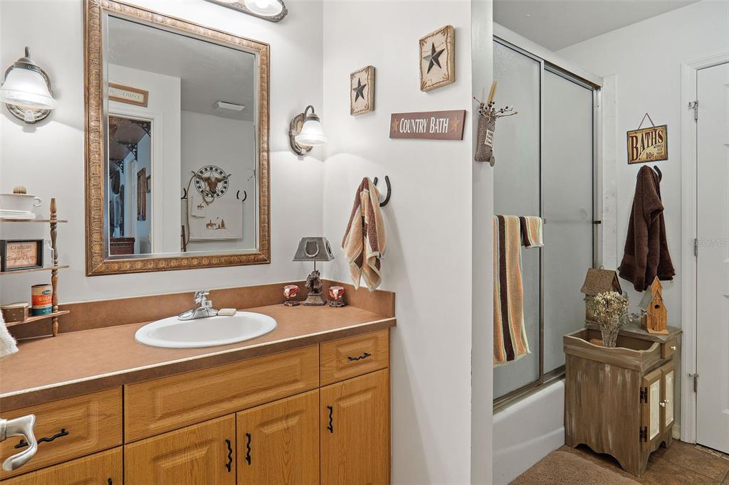 19355 Southwest 25th Place Dunnellon, FL 34431 - Photo 28 of 38 a bathroom with a sink vanity and mirror