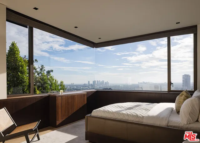 a bedroom with a bed window and a balcony