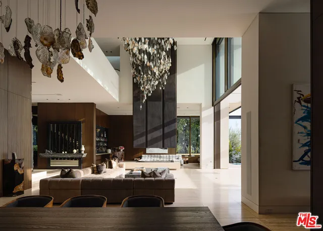 a view of a living room with furniture and a large window