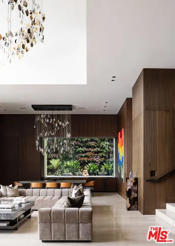 a living room with a couch and a floor to ceiling window