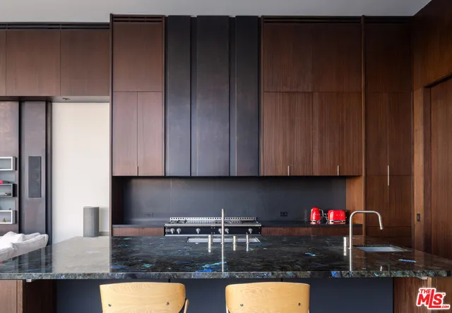 a kitchen with granite countertop cabinets and black appliances