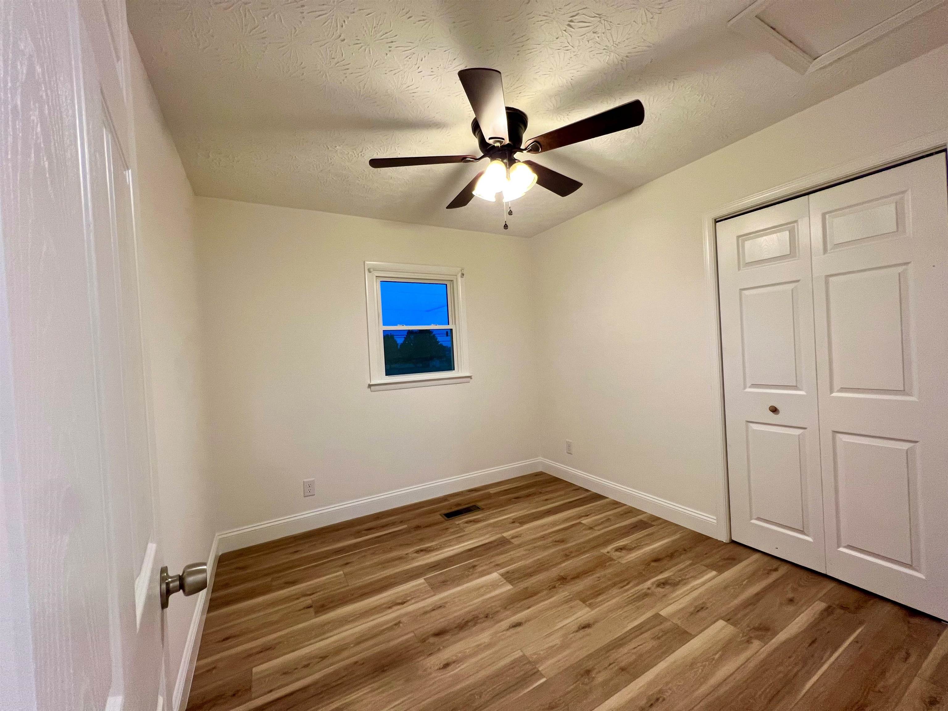 10293 Cook Town Road Bridgewater, VA 22812 - Photo 14 of 22 a view of a room with wooden floor and a ceiling fan