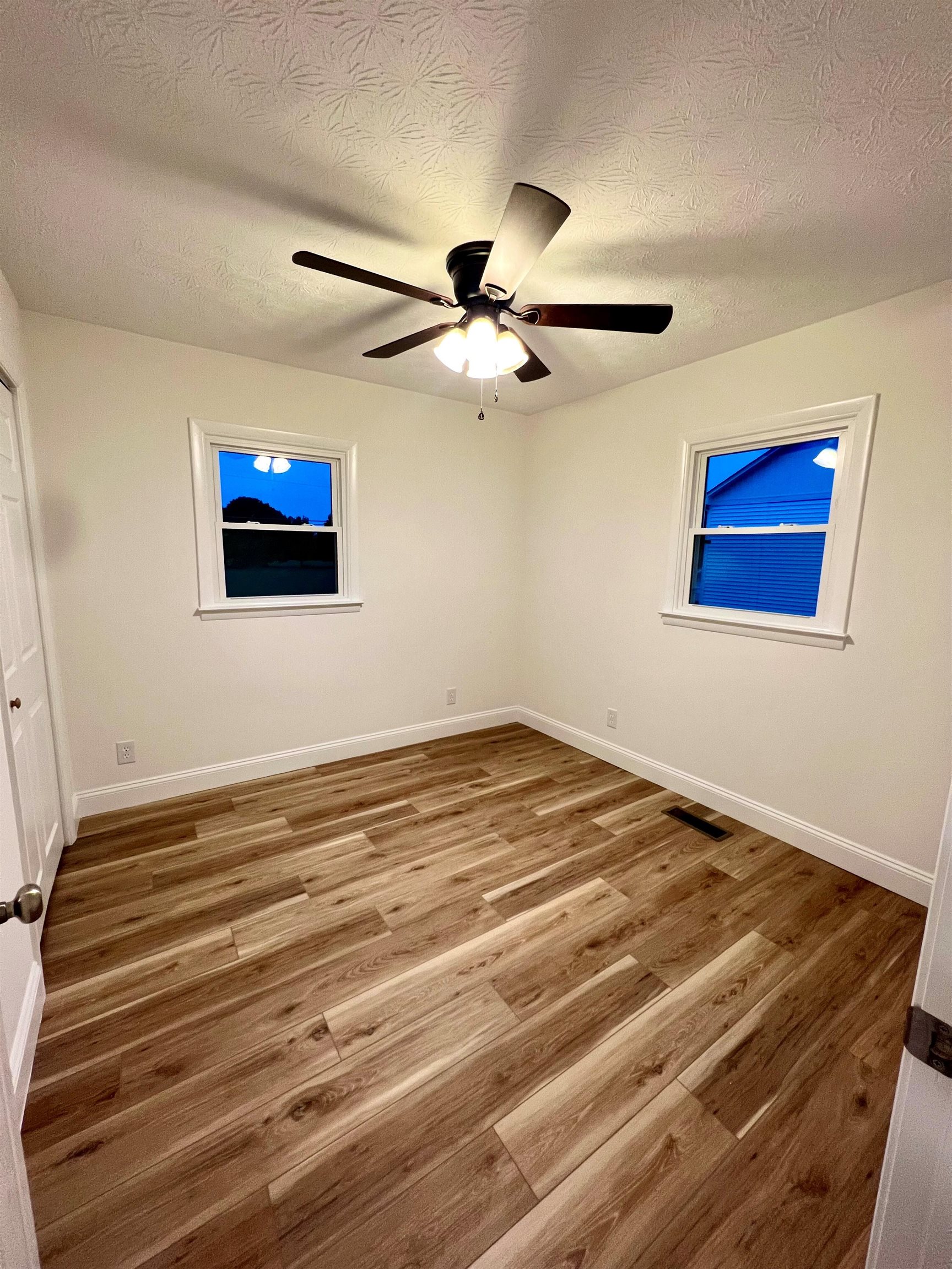 10293 Cook Town Road Bridgewater, VA 22812 - Photo 15 of 22 a view of a room with a ceiling fan and a hardwood floor