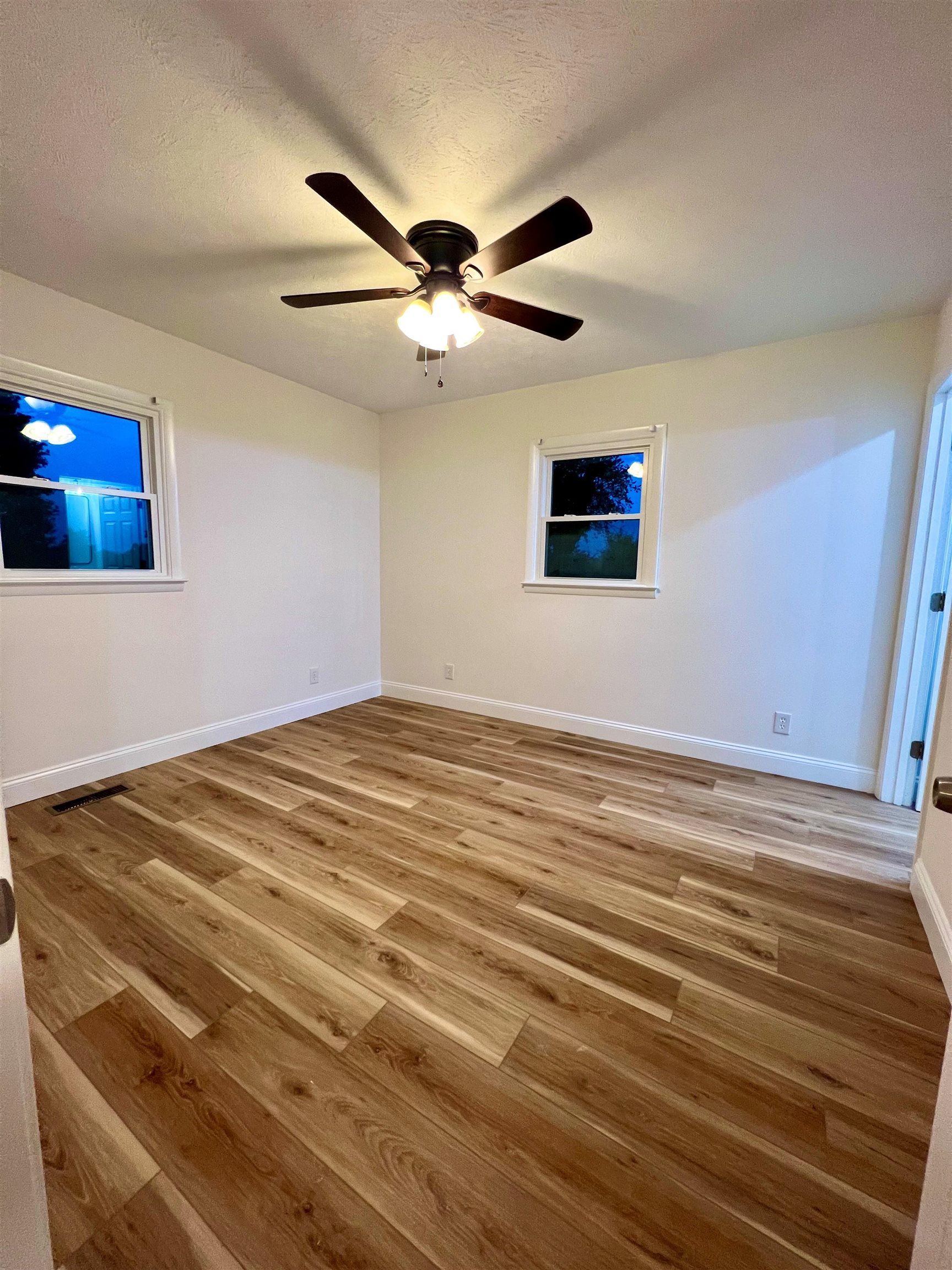 10293 Cook Town Road Bridgewater, VA 22812 - Photo 16 of 22 a view of a big room with wooden floor and chandelier fan