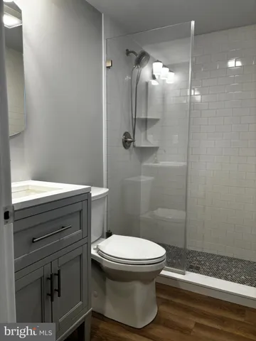 a bathroom with a toilet and a shower