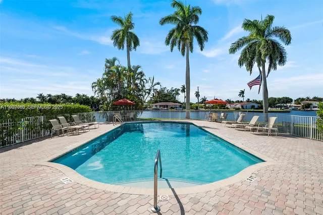 a view of a swimming pool with a table and chairs