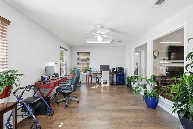 a living room with furniture potted plant and a window