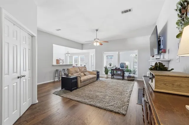 a living room with furniture and wooden floor