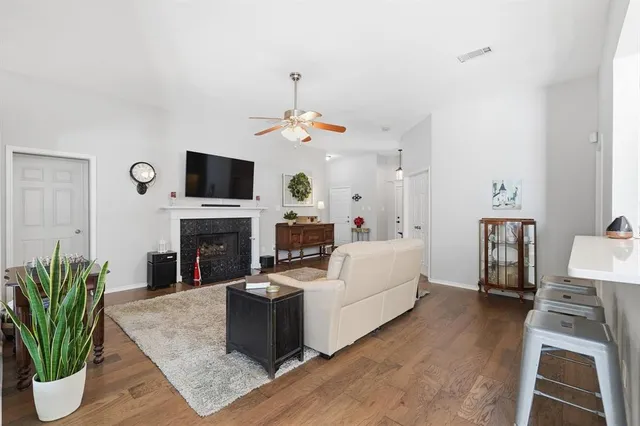 a living room with furniture a fireplace and a flat screen tv